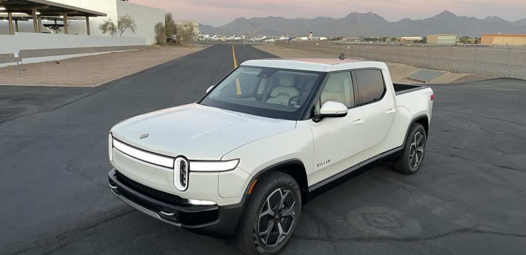 White Rivian R1T electric vehicle rental pickup truck located in Phoenix, Arizona.